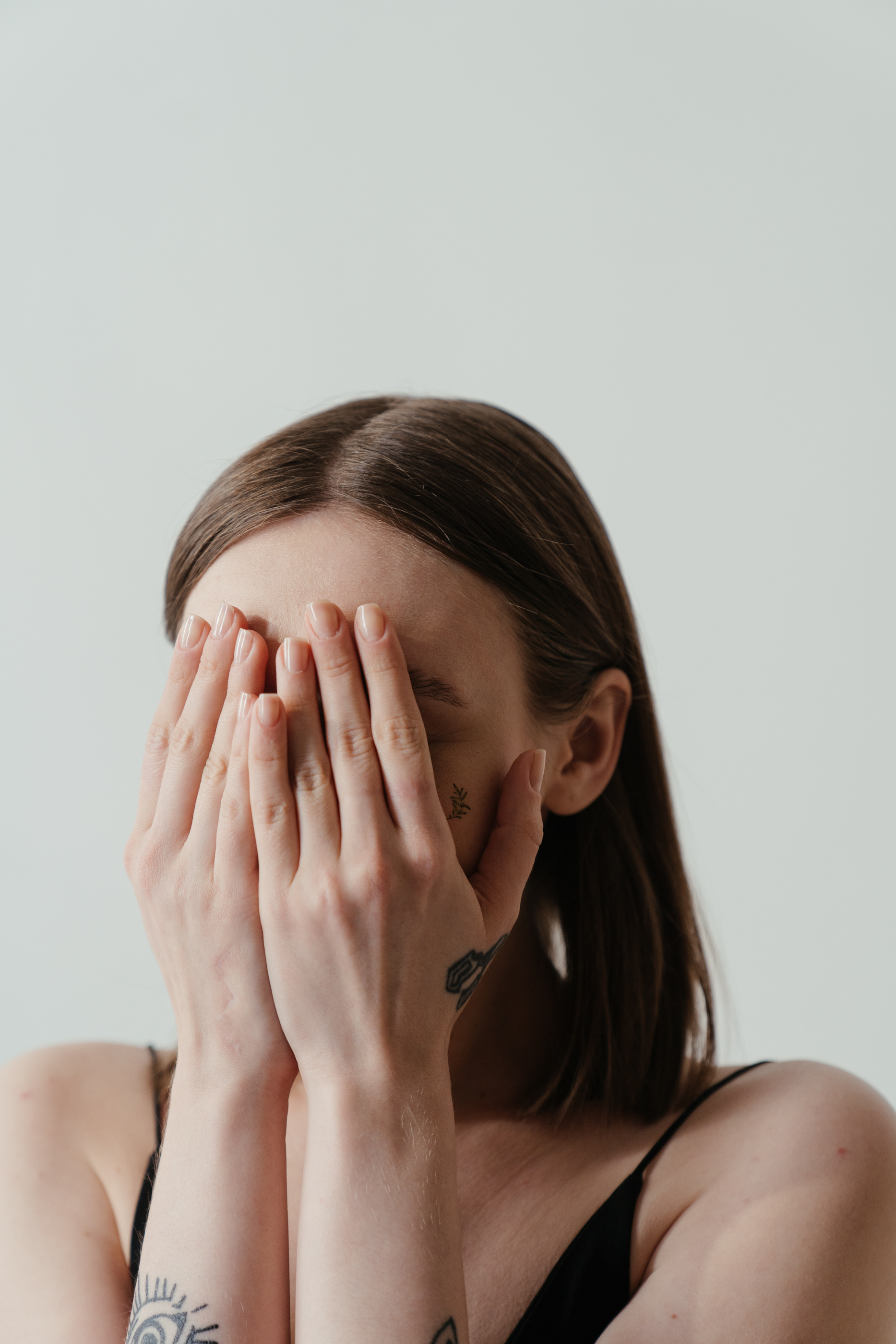 Woman Covering Her Face With Her Hands